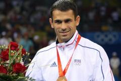 Bronze medalist Christophe Guenot of France pose on the podium of the men's Greco-Roman 74 kg wrestling category during the 2008 Beijing Olympic Games on August 13, 2008 in Beijing. Manuchar Kvirkelia of Georgia won gold, Chang Yongxiang of China won silver and Yavor Yanakiev of Bulgaria and Christophe Guenot of France claimed bronze. AFP PHOTO / VALERY HACHE / AFP / VALERY HACHE